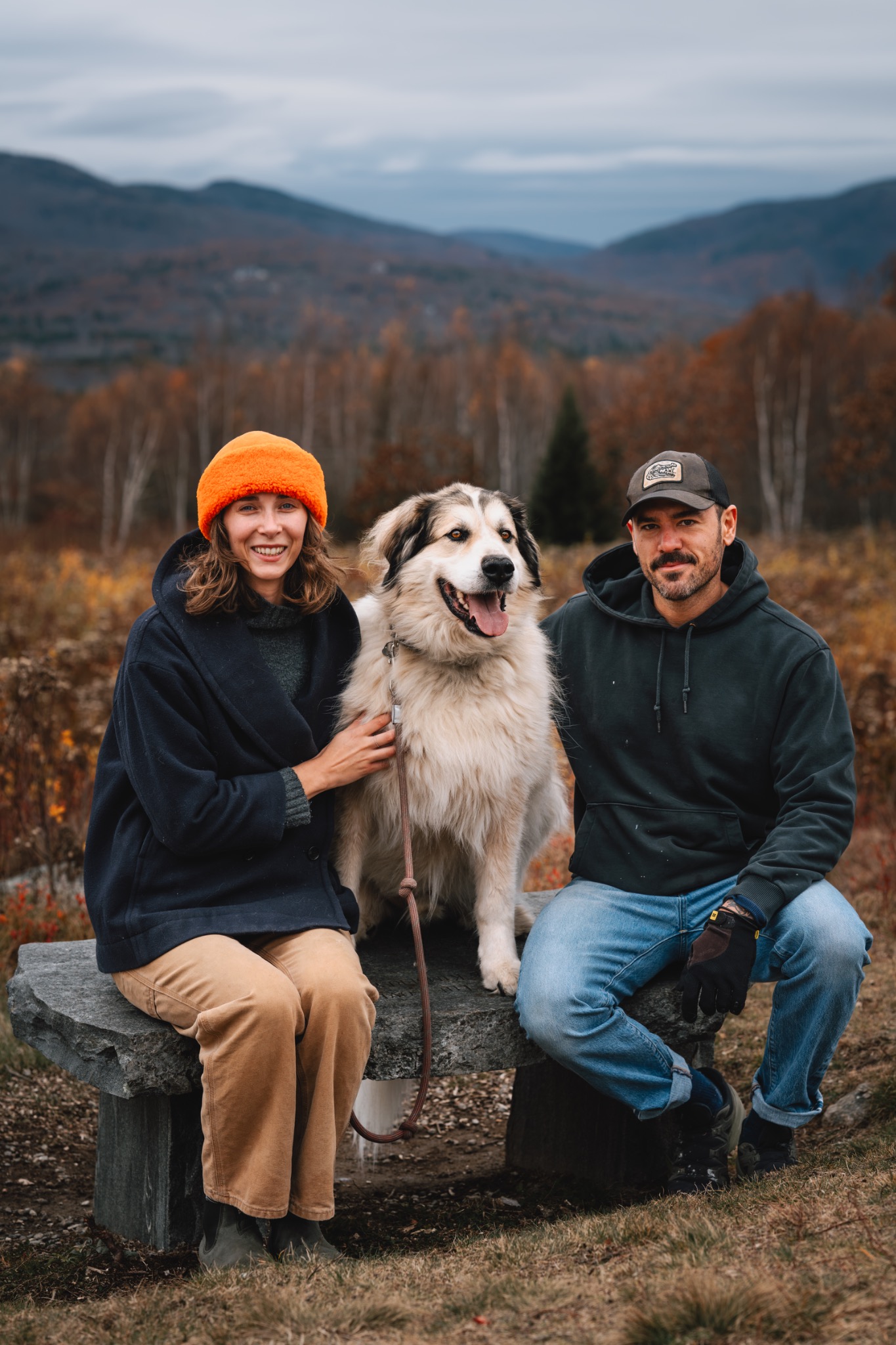 A couple with their dog in an autumn landscape